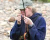 A participant in a 2007 Becoming an Outdoor Woman event ties a fly to her line during a fishing outing on Goose Creek. The program is currently registering participants for its 2016 events. F