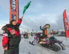 Kamela Towns waves the green flag as Team 24 leaves the chute during the start of the 2025 Iron Dog Saturday morning in Big Lake. Towns' was invited to start some of the racers in memory of a