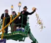 Rabbi Mendy Greenberg tosses gold-wrapped chocolates to children waiting below. It is symbolic of of the Maccabees’ victory, charity, and gratitude. Katie Stavick/Frontiersman