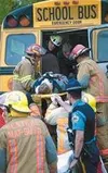 The last of three students is removed on a body board by Mat-Su
emergency responders Friday following an accident off Seldon Road
involving a car and a First Student bus from Tanaina Elementa