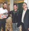 Traveling student rabbis Yisroel Treitel, from Montreal, and Levi Levertov, from Brooklyn, apply the teffillin to a fellow Jew they discovered outside the Wasilla Fred Meyer on one rainy day 