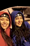 Jamie and Jennifer Christensen smile from inside their family's Alaska offshore fishing boat, a place they've called home the past few summers. Now the sisters and Colony High School graduate
