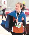 Wasilla's Peggy Mathis gives a smile and a thumbs-up to the crowd while taking a victory lap after winning the 4A girls 100-meter dash finals Saturday during the ASAA/First National Bank Stat