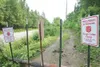 ROBERT DeBERRY/Frontiersman Metal posts, no tresspassing signs
and a log block a trail frequented by four wheeler enthusists near
Lake View Road in Wasilla. The closure of this trail forces t