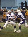 Charlie Bentti hands the ball off to Ali Larijani in the first
quarter. Photo by JEREMIAH BARTZ/ Frontiersman