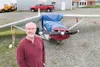 ROBERT DeBERRY/Frontiersman Palmer resident Dave Akers stands in
front of his wrecked Cessna 170 at the Palmer Airport. Akers, along
with passenger Gary Nall, crashed near Friday Creek July 2