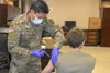 Indiana National Guard Spc. Christopher Santillan-Paiz administers a a COVID-19 vaccination to a 38th Infantry Division Soldier to maintain personal readiness and to bolster the National Guar