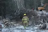 A member of the Greater Palmer Fire and Rescue walks near the scene of a tree-cutting accident on Saturday. Alaska State Troopers said a man was killed when the tree he was felling brought do