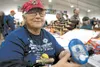 Aedene Arthur holds an avalanche beacon while manning her booth at Saturday’s Palmer Lions Club Gun Show at Raven Hall at the Alaska State Fairgrounds. Robert DeBerry