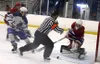 The pucks rolls through the edge of the crease next to East Anchorage goalie Lane Fox after Pamer freshman Jaron Ketterman fired a shot on net during the final moments of a 3-3 tie at the MTA