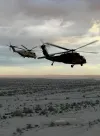 An Alaska Army National Guard UH-60L Black Hawk flies alongside a U.S. Marine Corps CH-53E Super Stallion near Marine Corps Air Station Yuma during the early phase of the Marine Weapons and T