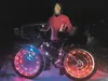 Jennifer Bostick with her lit-up fat bike after last Saturday night’s Global Fat Bike Day ride outside Palmer. MATT HICKMAN/Frontiersman