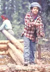 Luke Irons uses a hand drill to make peg holes in the logs his family felled to build a log cabin in the Brooks Range in 1992-93. The experience is the subject of a book an documentary by the