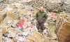 ROBERT DeBERRY/Frontiersman Dick Divelbiss stands on the piles
of incoming newsprint that will be recycled into insulation at the
Thermo-Kool of Alaska Inc. facility in Wasilla.