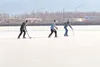 Ben Crafton, Jeremy Carter and Nick Simpson play hockey on the ice of Wasilla Lake Monday afternoon. Mat-Su Borough officials are urging residents to stay off recently formed ice on area lake