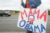 ROBERT DeBERRY/Frontiersman A Barack Obama supporter holds a
pair of support signs Friday at the corner of Crusey Street and the
Parks Highway in Wasilla.