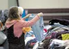 A visitor to the 2012 Mat-Su Promise Homeless Connect looks through clothing. This year’s Homeless Connect is Wednesday from 10 a.m. to 3 p.m. ROBERT DeBERRY/Frontiersman.com