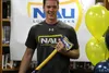 Colony HIgh School senior Jarek Schultz holds a gift from his parents, a blue and gold ax with the Northern Arizona University logo, during a ceremony Wednesday afternoon at Colony High Schoo