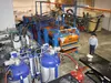 Alaska Insulated Panels owner Ron Burkhardsmeier stands near the polyurethane foam tanks and panel press at his Wasilla shop Friday, Dec. 18. Burkhardsmeier’s process injects polyurethane foa