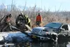 Happy Hooker Towing employees pry a 2012 Ford F150 out of the water in Wasilla Creek on the Palmer Hay Flats State Game Refuge on Wednesday morning. CAITLIN SKVORC/Frontiersman.com