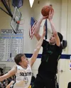 Colony's Patrick McMahon puts up a jumpshot over Soldotna's Tyler Morrison (4) Friday night at Soldotna High School. Photo by Joey Klecka/Peninsula Clarion