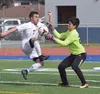 Homer goalkeeper Kenzington Cortez (right) makes a save on the ball against Colony striker Ben Sande in a Northern LIghts Conference tournament quarterfinal Thursday afternoon at Justin Maile