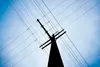 Power lines crisscross as they pass across a large power pole near Carrs/Safeway and the Parks Highway in Wasilla. Matanuska Electric Association has switched gears on a plan to run transmiss