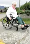 Pioneer Home resident Jessie DeVries carefully makes her way
along a sidewalk in Palmer. Last week she testified before the
Palmer City Council that many sidewalks and streets around town are