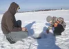 Mikhail Gedz and son Daniel, 7, work their fishing hole during
Saturday’s Big Lake Ice Fishing Derby. (ROBERT
DeBERRY/Frontiersman)