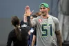 Former Seattle Seahawks All-Pro Lofa Tatupu high-fives a participant during the girls flag football clinic. Jeremiah Bartz/Frontiersman