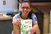 Burchell High School senior Naomi DeMott displays her new book,
"Danny the Dragon." Photo by JOEL DAVIDSON/Frontiersman.