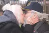 GREG JOHNSON/Frontiersman Barbara Caswell holds onto her
husband, David’s, beard to give him a good-luck kiss Sunday at the
first Alaska State Fair Beard and Mustache Contest.
