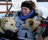 Nicole Osmar clutches her lead dogs after winning the 2004
Junior Iditarod Sled Dog Race. The 15-year-old Ninilchik musher
rolled into Susitna Landing at 9:54 Sunday morning to win the
title.
