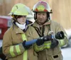 Firefighter Jana Powell work on the proper technique for door
entry with Explorers Ruth Jacob. (ROBERT DeBERRY/Frontiersman)