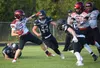 Houston running back Cody Wyrick tries to get past Nikiski's Truit McCaughey and Christian Caddock on Friday, Aug. 27, 2021, at Nikiski High School in Nikiski. Jeff Helminiak/Peninsula Clario