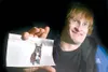 ROBERT DeBERRY/Frontiersman file photo Wasilla resident Jack
Runser with a photograph of his service dog, Sheba, who was killed
last year by an automobile. While training with a new service
a