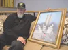 Bob Barton sits with an acrylic painting of the World Trade Center done by his wife, Claire Barton, in 2003. The painting will be on display at their daughter's place of business, Aurora Flow