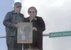 James Sr. and Wanda Rowland stand near Rowland Memorial Way in
Palmer holding a photograph of their son, James Rowland Jr., with
his son. Rowland Jr. was shot and killed in the line of duty a