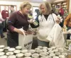 Volunteer Christy Pahkala, left, helps Quinell Lynn gather food
during the 2010 Valley Thanksgiving Blessing at Good Shepherd
Lutheran Church in Wasilla. More than 1,200 local families attend