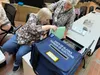 Poll workers set up an early voting station in the atrium of the State Office Building in Juneau, Alaska on Monday, Aug. 5, 2024, the first day of early voting for the 2024 Alaska primary ele