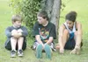 ROBERT DeBERRY/Frontiersman Twelve-year-old Zachery Doss, left,
talks with brother Brandon, 14, and friend Devin Johnson at the
scene of a fire Monday evening at 7350 N. Esther Drive.