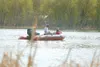 ROBERT DeBERRY/Frontiersman A boat carrying three fishermen
motors across Finger Lake Monday afternoon.