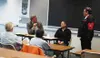 Rep. Vic Kohring, left, asks a follow-up question of former Mat-Su Borough Assembly member Dan Kelly during his Saturday town meeting. Rep. Carl Gatto, center, also took part in the meeting i