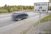 A new sign posted on Big Lake Road just before the intersection
with the Parks Highway warns drivers that they must drive with
their headlights on when in the safety corridor of the Parks
Hig