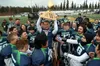Redington senior Wayde Bowman lifts the trophy as the Huskies celebrate their win in the Division III state football championship game. Bruce Eggleston/matsusports.net