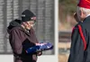 Kandi Rohr receives her father William Lee's flag after it was retired during the Vietnam Veterans Memorial Day March 29, 2025. J. David McChesney/Frontiersman