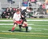 Wasilla’s Chance Morrison and Colony’s Harrison Menard get tangled up while going for the ball during Thursday’s game at Colony High School. ROBERT DeBERRY/Frontiersman.com