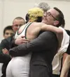 Colony High assistant coach Hollan Gravely hugs Levi Hopkins after Hopkins won his first career state title as a freshman during the ASAA/First National Bank 4A State Wrestling Championships 