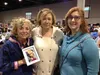 DeeDee Jonrowe smiles for a photo with New Hampshire fans Candi Kane, center, and Zoe Roberge at the Iditarod mushers' banquet on Thursday evening, after tearfully receiving a photo of her mo