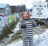 Ricky Browning of Palmer stands on the corner of the Glenn and Palmer-Wasilla Highways on Nov. 8 wearing a Hillary Clinton mask and hoisting a sign, “It’s time to drain the Swamp.” Browning s